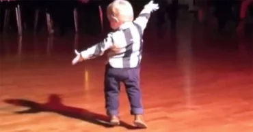 Baby hears favorite Elvis song at party and has the whole crowd cracking up at his moves